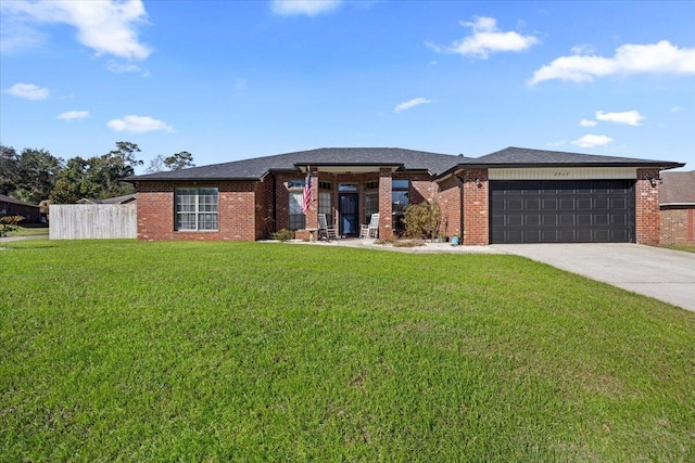 prairie-style house featuring a garage, concrete driveway, a front yard, and fence