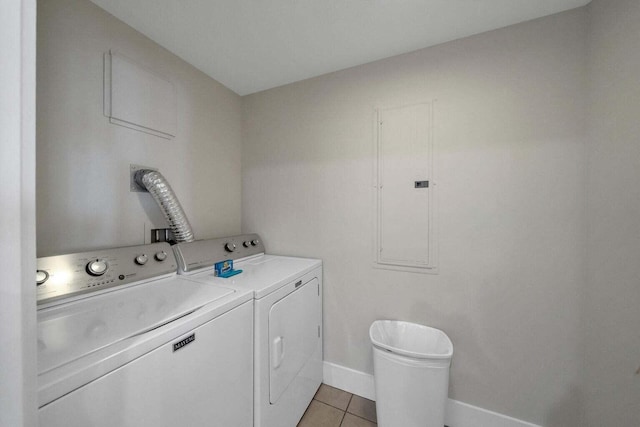 laundry area featuring light tile patterned floors and washing machine and dryer