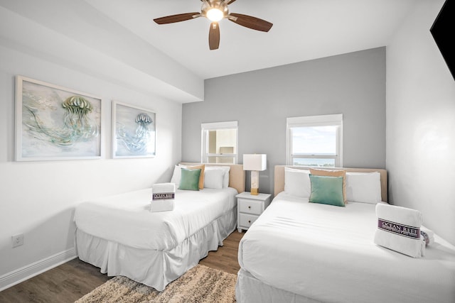 bedroom featuring wood finished floors, a ceiling fan, and baseboards