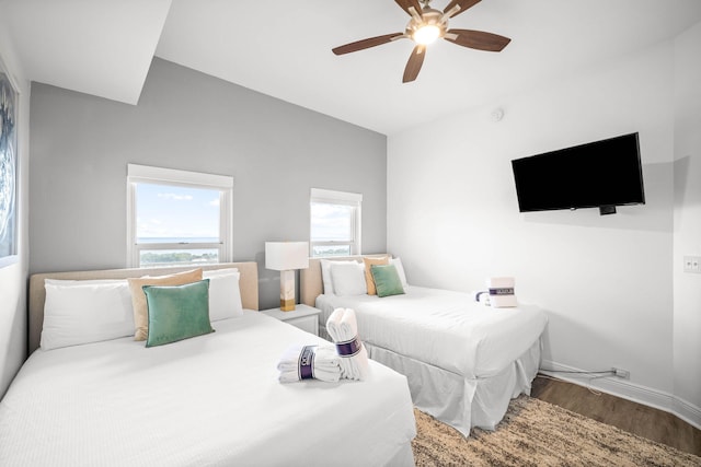 bedroom with ceiling fan, baseboards, and wood finished floors