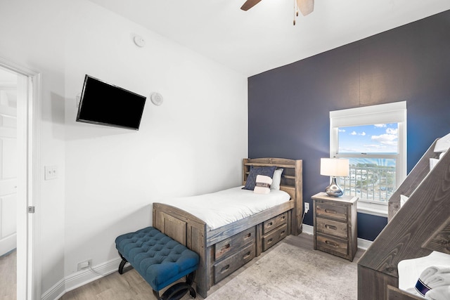 bedroom featuring ceiling fan, light wood-type flooring, and baseboards