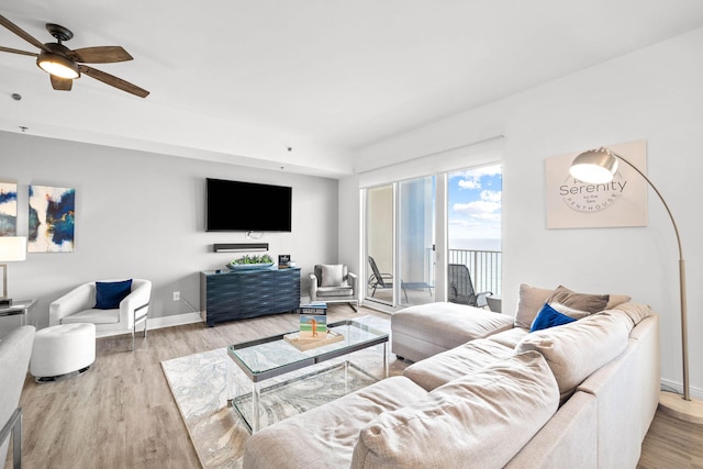 living room with ceiling fan, wood finished floors, and baseboards