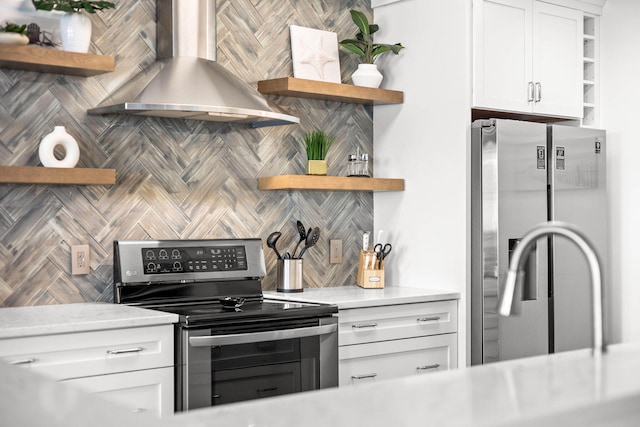 kitchen with stainless steel appliances, white cabinetry, wall chimney range hood, backsplash, and open shelves