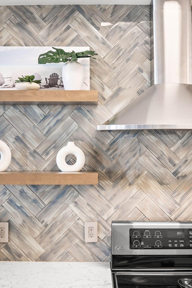 interior space featuring wall chimney exhaust hood and electric stove