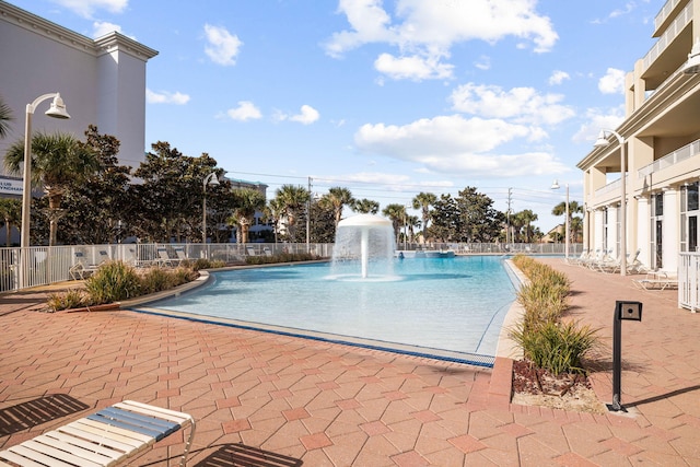 view of swimming pool with fence