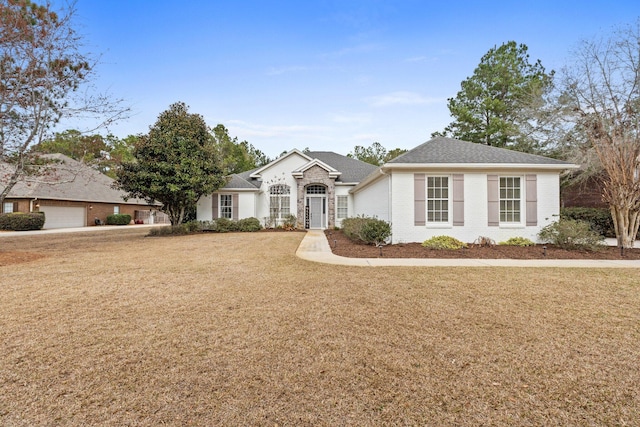 single story home featuring a garage and a front yard