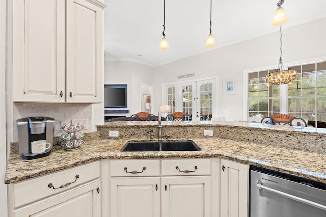 kitchen with white cabinetry, dishwasher, sink, and a healthy amount of sunlight