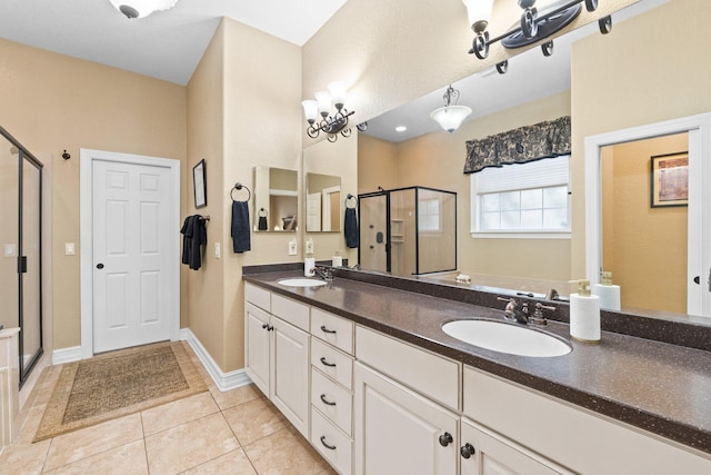 bathroom featuring vanity, a shower with door, and tile patterned floors