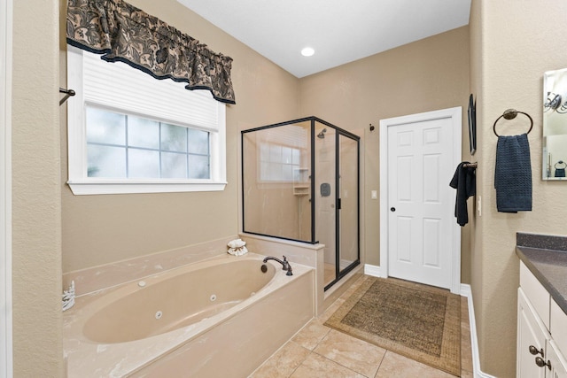 bathroom featuring tile patterned floors, shower with separate bathtub, and vanity