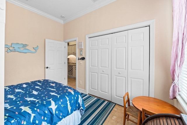 bedroom featuring tile patterned flooring, crown molding, and a closet