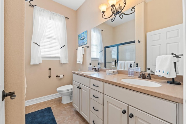 bathroom featuring vanity, toilet, a chandelier, and tile patterned flooring