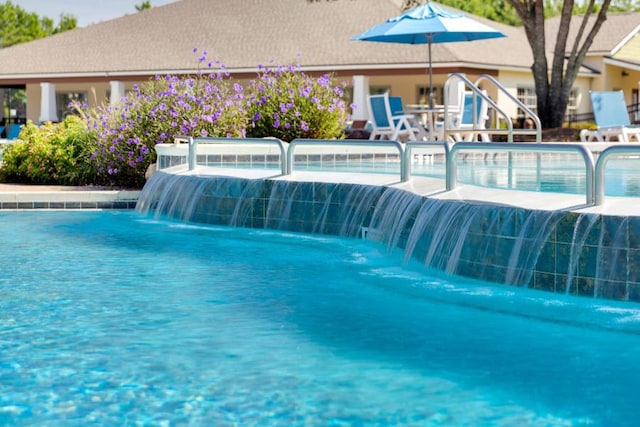 view of swimming pool featuring pool water feature