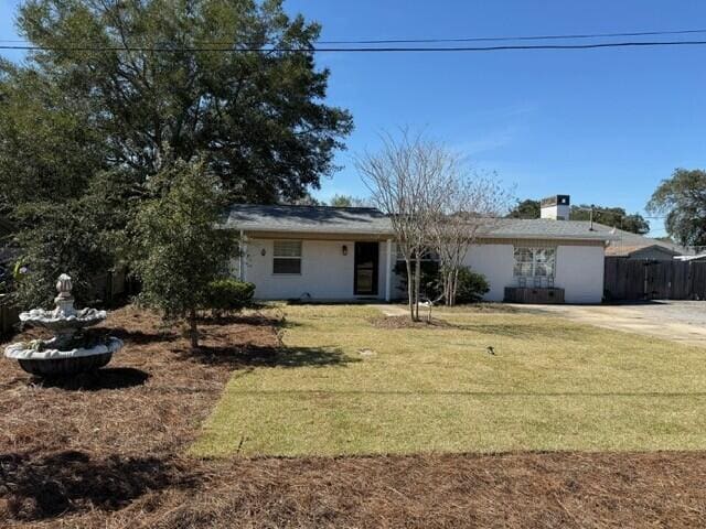 view of front of property with a front yard and fence