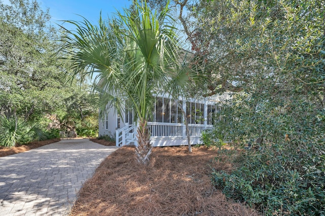 view of property exterior featuring a sunroom