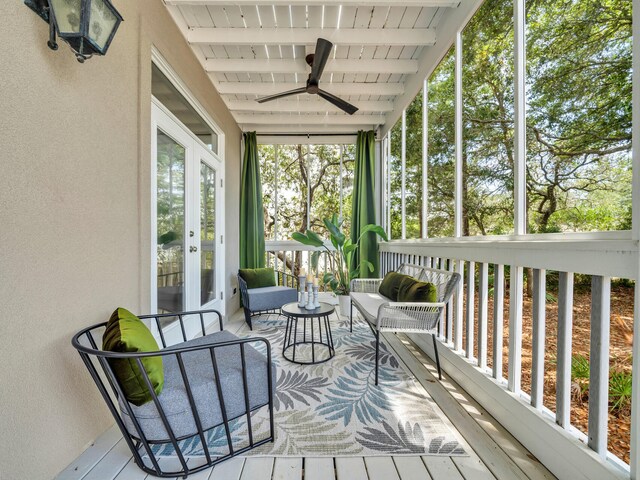 sunroom / solarium with ceiling fan, beam ceiling, and wooden ceiling