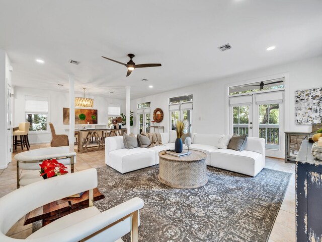 tiled living room with french doors and ceiling fan