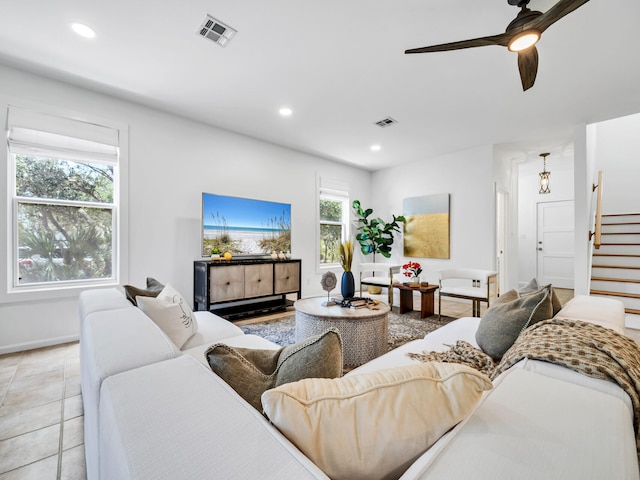 living room featuring light tile patterned flooring and ceiling fan