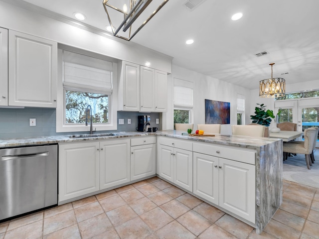 kitchen featuring decorative light fixtures, dishwasher, sink, and white cabinets