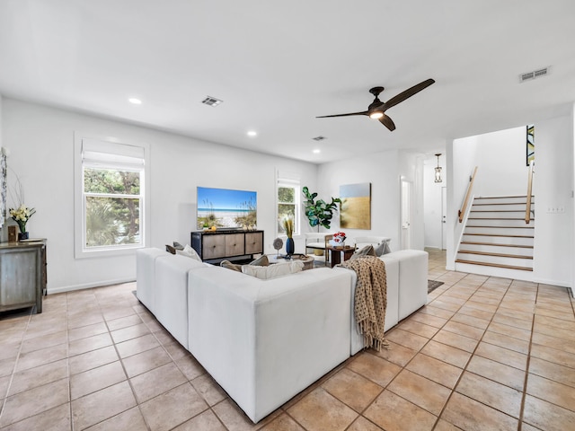 living room with ceiling fan and light tile patterned flooring