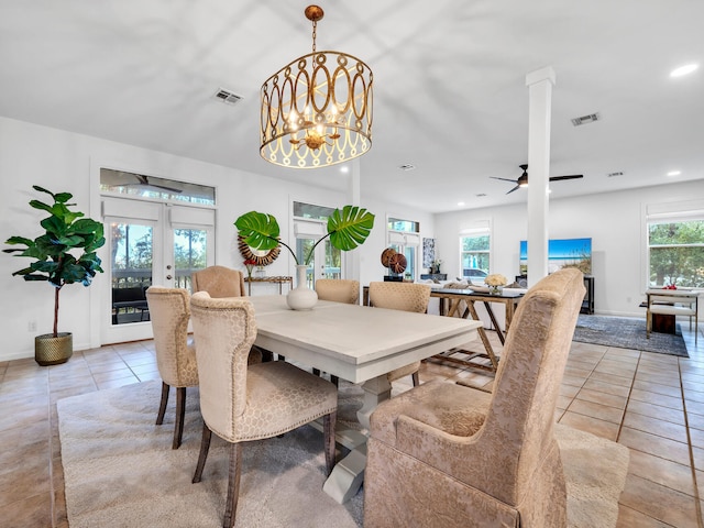 dining area with light tile patterned floors, ceiling fan with notable chandelier, and french doors