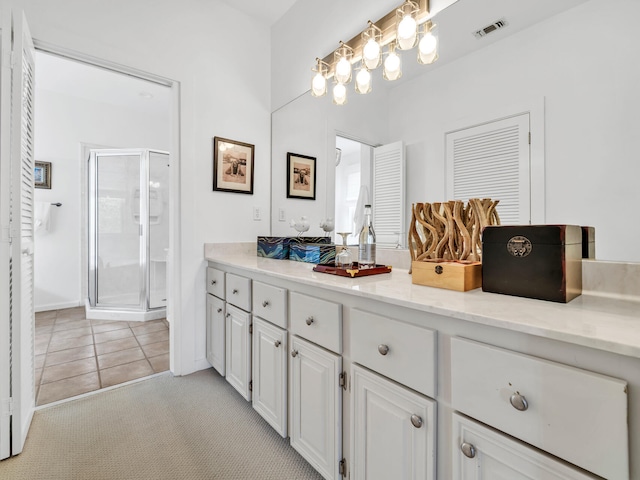 bathroom featuring an enclosed shower, vanity, and tile patterned floors