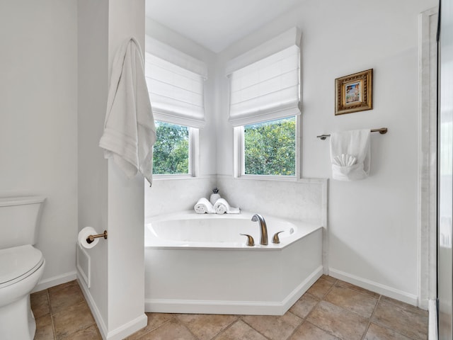 bathroom with toilet and a bath