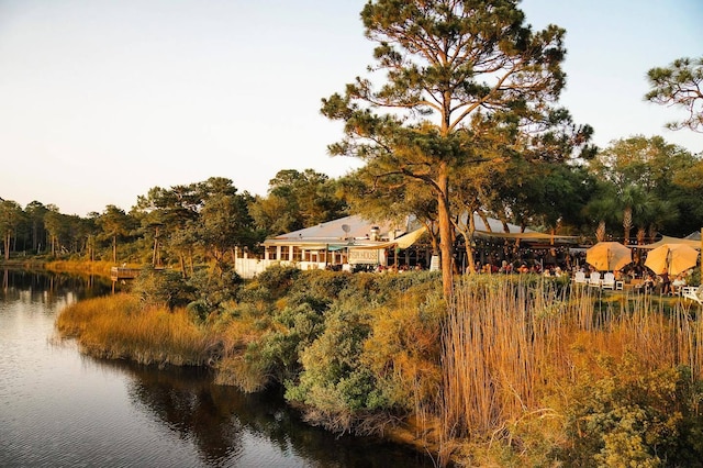 back of property featuring a water view