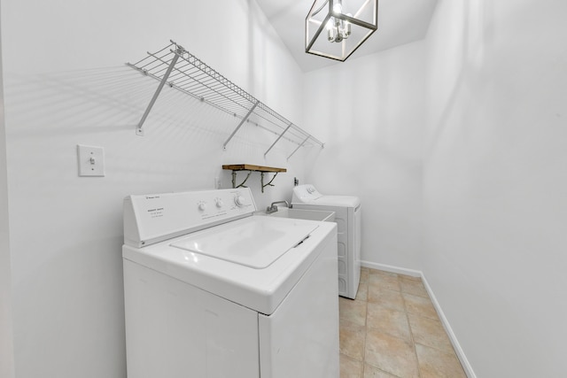 washroom featuring washing machine and dryer and light tile patterned floors