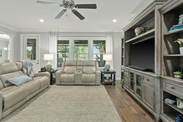 living room featuring crown molding, ceiling fan, and dark hardwood / wood-style flooring