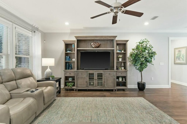 living room featuring ceiling fan, ornamental molding, and dark hardwood / wood-style floors