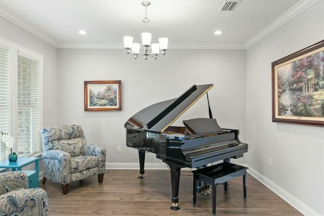 miscellaneous room with an inviting chandelier, hardwood / wood-style flooring, and ornamental molding