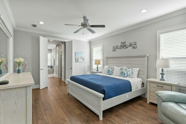 bedroom featuring crown molding, ceiling fan, dark hardwood / wood-style floors, and a barn door