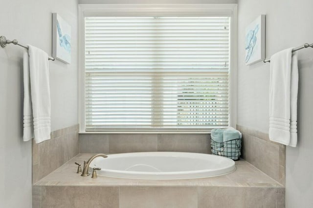 bathroom featuring tiled bath