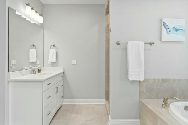 bathroom featuring vanity and tiled bath