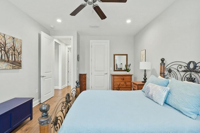 bedroom with hardwood / wood-style floors and ceiling fan