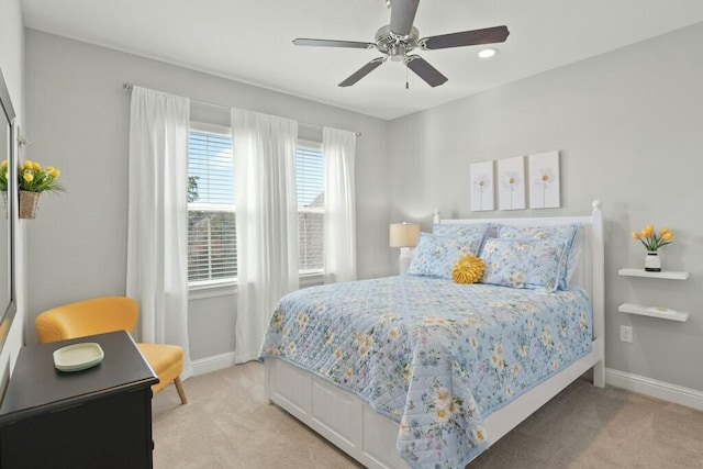 bedroom featuring ceiling fan and light carpet