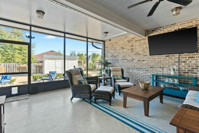 sunroom / solarium with beamed ceiling and ceiling fan