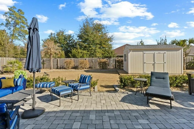 view of patio with a storage shed and an outdoor living space