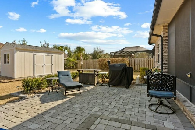 view of patio featuring grilling area and a storage unit