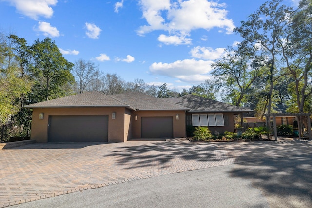 view of front facade with decorative driveway and an attached garage