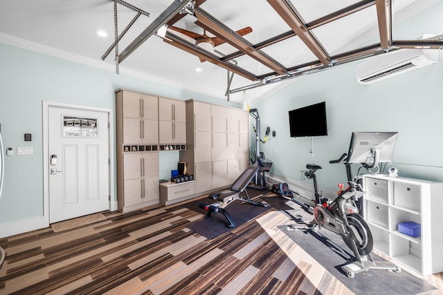 workout room featuring a garage, a wall unit AC, ornamental molding, and baseboards