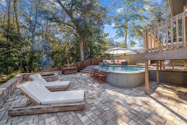 view of patio with an outdoor living space with a fire pit, stairway, a fenced backyard, and a fenced in pool