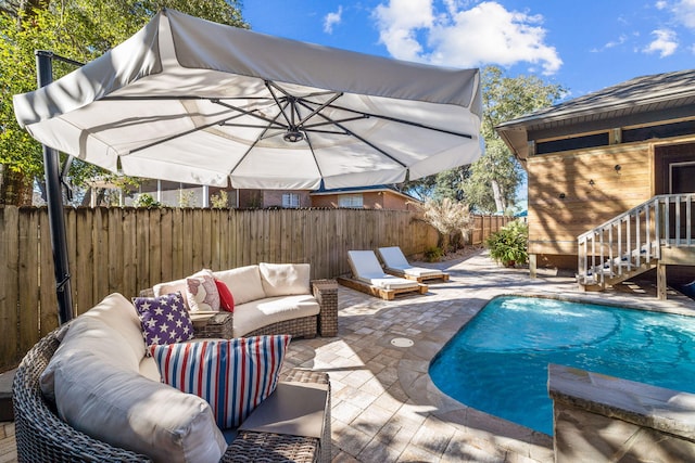 view of pool with a fenced backyard, an outdoor living space, a fenced in pool, and a patio