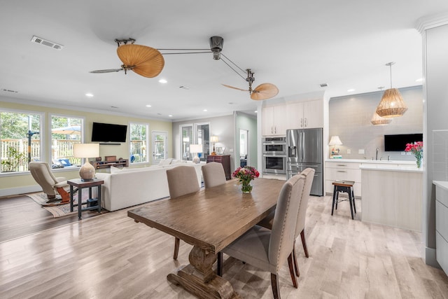 dining room featuring ornamental molding, recessed lighting, visible vents, and light wood finished floors