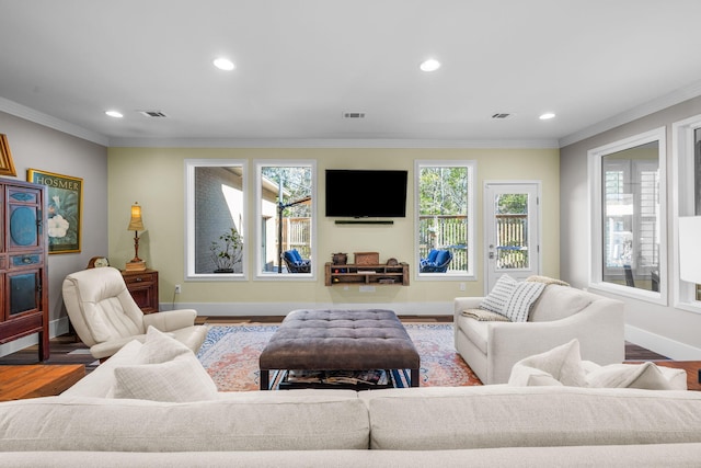 living room featuring visible vents, crown molding, and wood finished floors