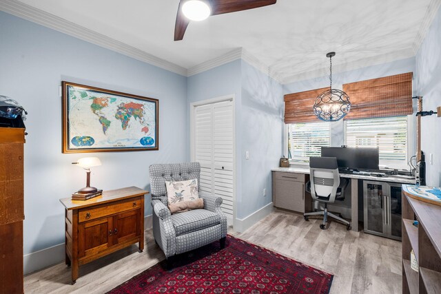 home office with baseboards, light wood finished floors, ceiling fan with notable chandelier, and crown molding