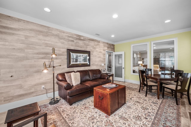 living room with recessed lighting, an accent wall, visible vents, baseboards, and crown molding