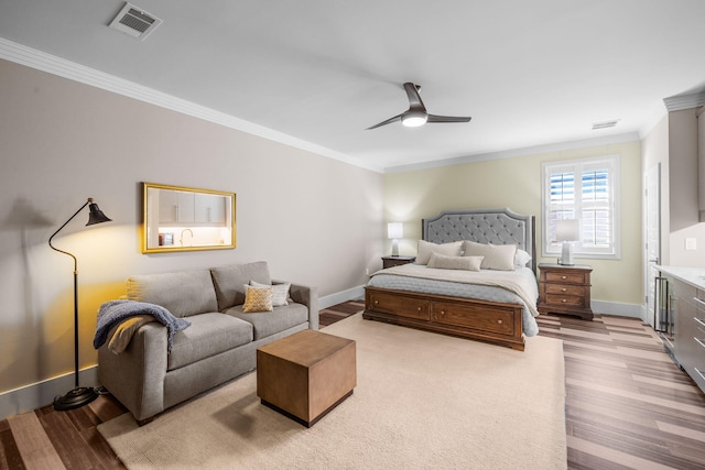 bedroom featuring light wood finished floors, visible vents, ornamental molding, a ceiling fan, and baseboards