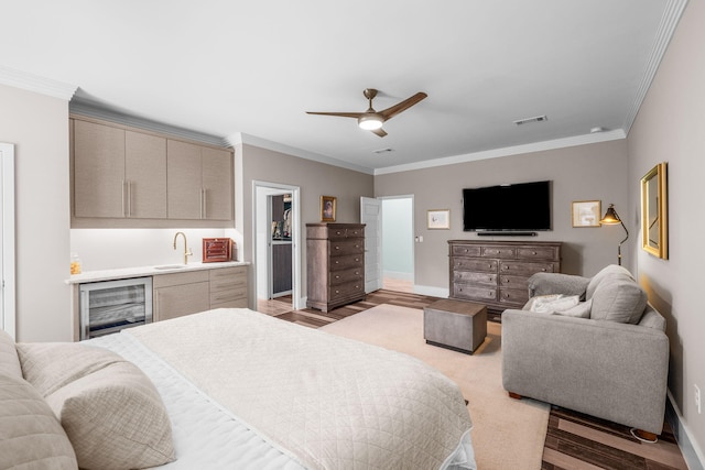 bedroom with crown molding, visible vents, a sink, wet bar, and beverage cooler