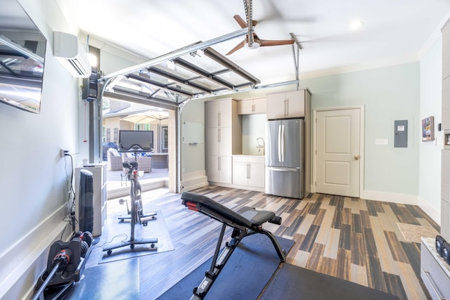 exercise area featuring crown molding, a wall mounted AC, ceiling fan, electric panel, and baseboards